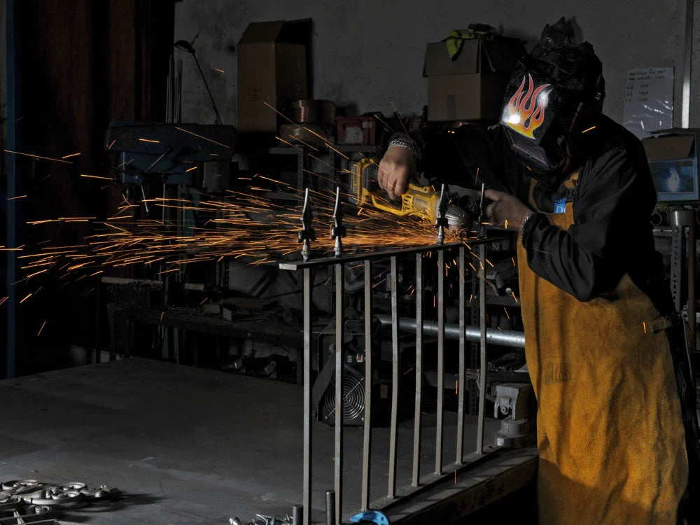 Fabricator at Work with Metal Fence Posts